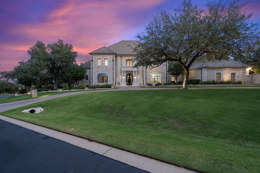 208 Bella Riva Drive, Austin, Texas seated on a well-manicured acre lot with complete privacy and lake views in the coveted gated community of Costa Bella on Lake Travis boasting timeless, high-quality craftsmanship abounds in every corner.