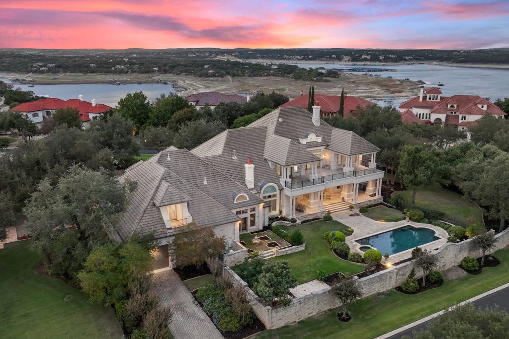 208 Bella Riva Drive, Austin, Texas seated on a well-manicured acre lot with complete privacy and lake views in the coveted gated community of Costa Bella on Lake Travis boasting timeless, high-quality craftsmanship abounds in every corner.