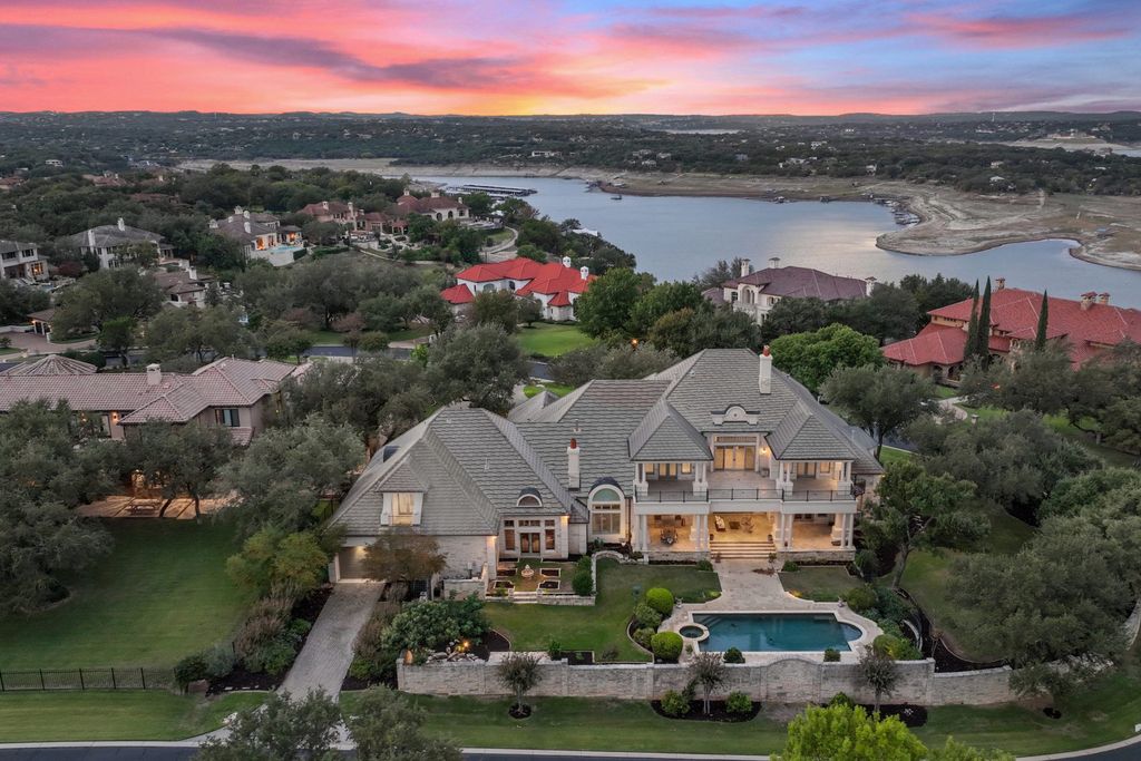 208 Bella Riva Drive, Austin, Texas seated on a well-manicured acre lot with complete privacy and lake views in the coveted gated community of Costa Bella on Lake Travis boasting timeless, high-quality craftsmanship abounds in every corner.