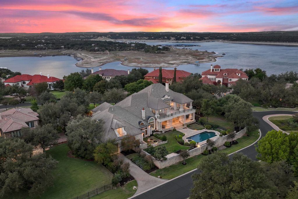208 Bella Riva Drive, Austin, Texas seated on a well-manicured acre lot with complete privacy and lake views in the coveted gated community of Costa Bella on Lake Travis boasting timeless, high-quality craftsmanship abounds in every corner.