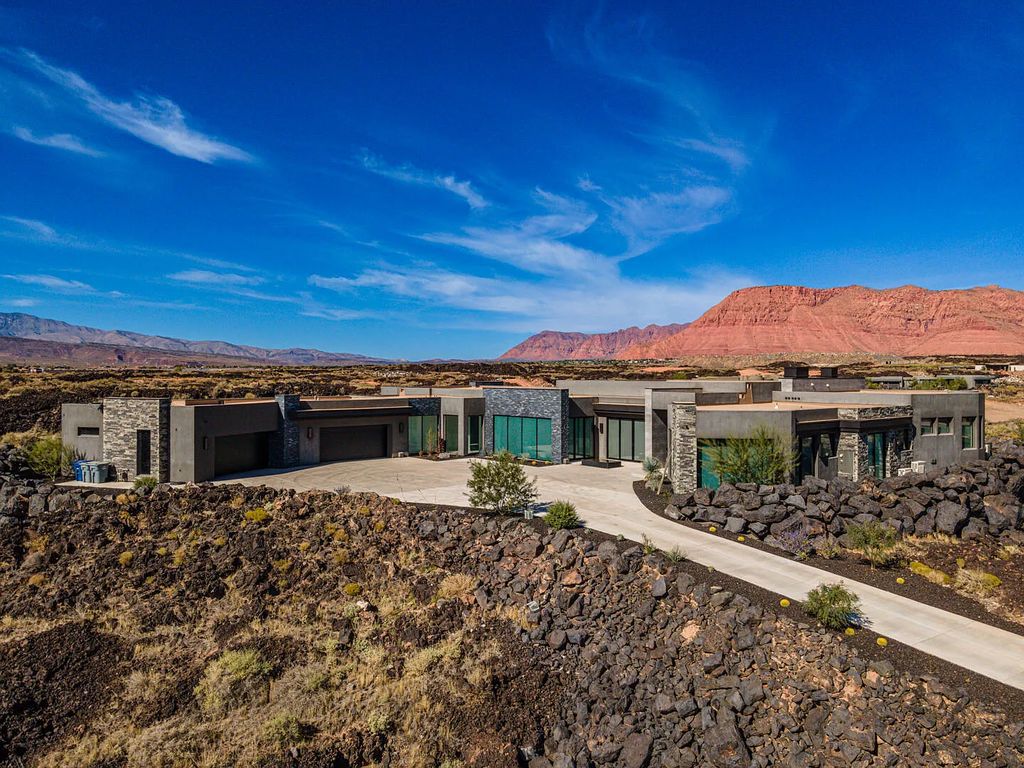 2399 N Kiva Trail, Saint George, Utah is a truly one of a kind contemporary estate sits 28 feet above the street below, boasts 360 degree views, including a picture perfect framing of Snow Canyon, Red Mountain, Pine Valley Mountain, Movie Rock, and the Kachina Cliffs.