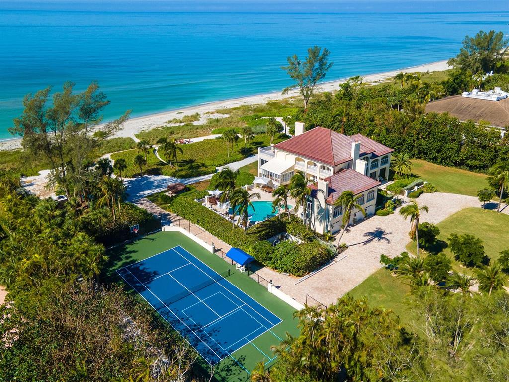8218 Sanderling Rd, Sarasota, Florida is a private resort-like compound with over 300 feet of direct beachfront rests on over 4-acres between the tranquil blue Gulf of Mexico waters and the quiet banks of Heron Lagoon in the Sanderling Club.