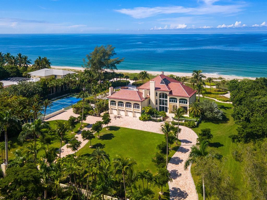 8218 Sanderling Rd, Sarasota, Florida is a private resort-like compound with over 300 feet of direct beachfront rests on over 4-acres between the tranquil blue Gulf of Mexico waters and the quiet banks of Heron Lagoon in the Sanderling Club.