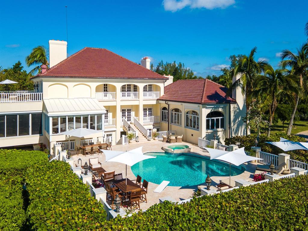 8218 Sanderling Rd, Sarasota, Florida is a private resort-like compound with over 300 feet of direct beachfront rests on over 4-acres between the tranquil blue Gulf of Mexico waters and the quiet banks of Heron Lagoon in the Sanderling Club.