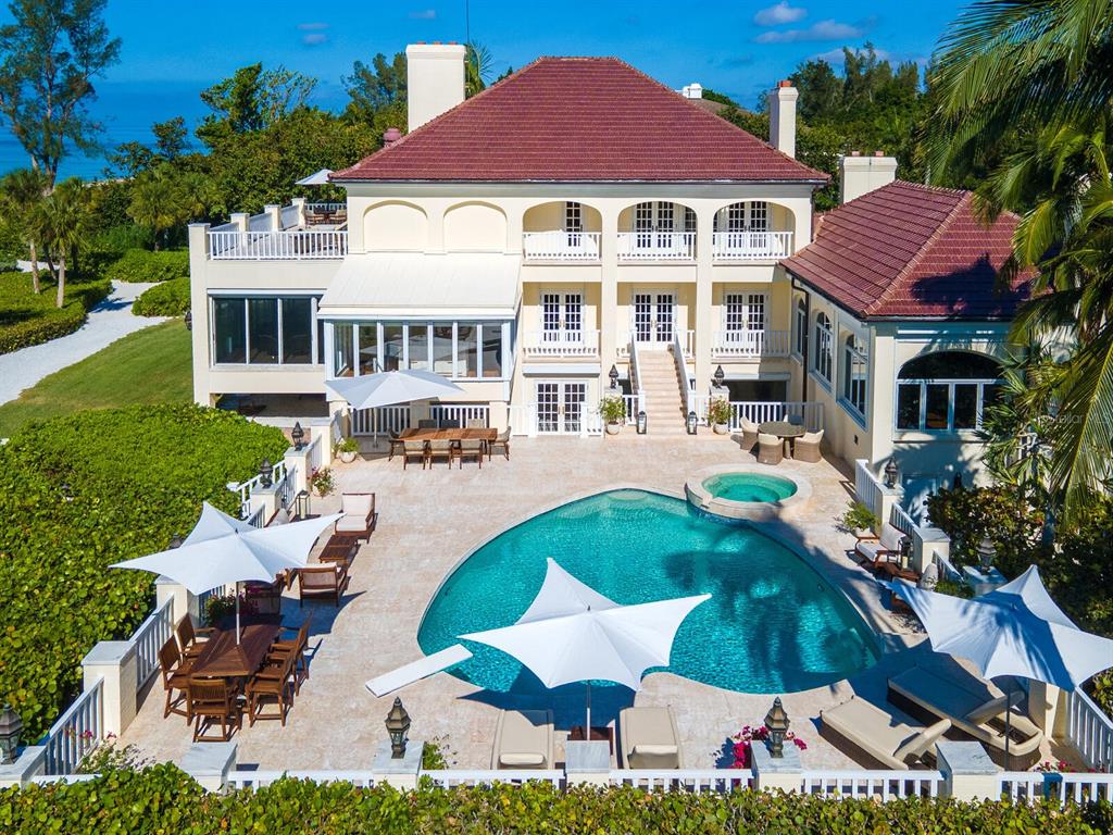 8218 Sanderling Rd, Sarasota, Florida is a private resort-like compound with over 300 feet of direct beachfront rests on over 4-acres between the tranquil blue Gulf of Mexico waters and the quiet banks of Heron Lagoon in the Sanderling Club.