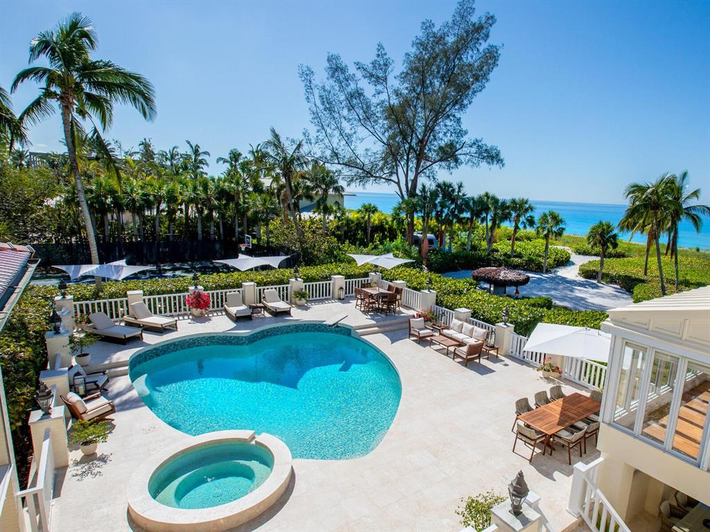 8218 Sanderling Rd, Sarasota, Florida is a private resort-like compound with over 300 feet of direct beachfront rests on over 4-acres between the tranquil blue Gulf of Mexico waters and the quiet banks of Heron Lagoon in the Sanderling Club.