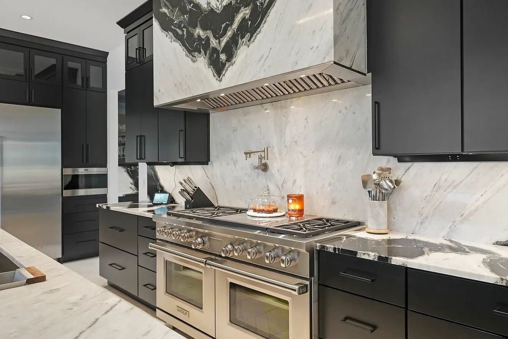The Estate in Lincolnshire offers a grand scale foyer, ebony oak floors, an open floor plan, soaring ceiling heights, custom luxury finishes throughout now available for sale. This home located at 23477 N Elm Rd, Lincolnshire, Illinois