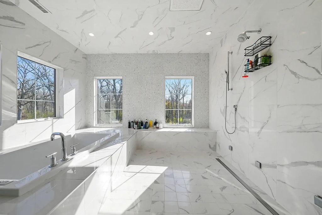 The Estate in Lincolnshire offers a grand scale foyer, ebony oak floors, an open floor plan, soaring ceiling heights, custom luxury finishes throughout now available for sale. This home located at 23477 N Elm Rd, Lincolnshire, Illinois