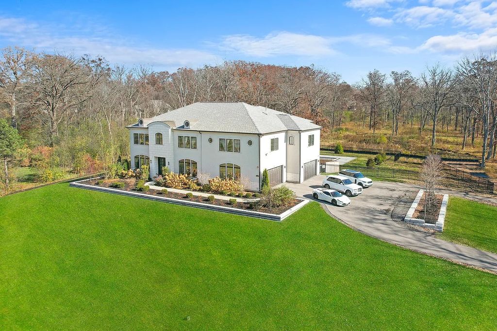 The Estate in Lincolnshire offers a grand scale foyer, ebony oak floors, an open floor plan, soaring ceiling heights, custom luxury finishes throughout now available for sale. This home located at 23477 N Elm Rd, Lincolnshire, Illinois