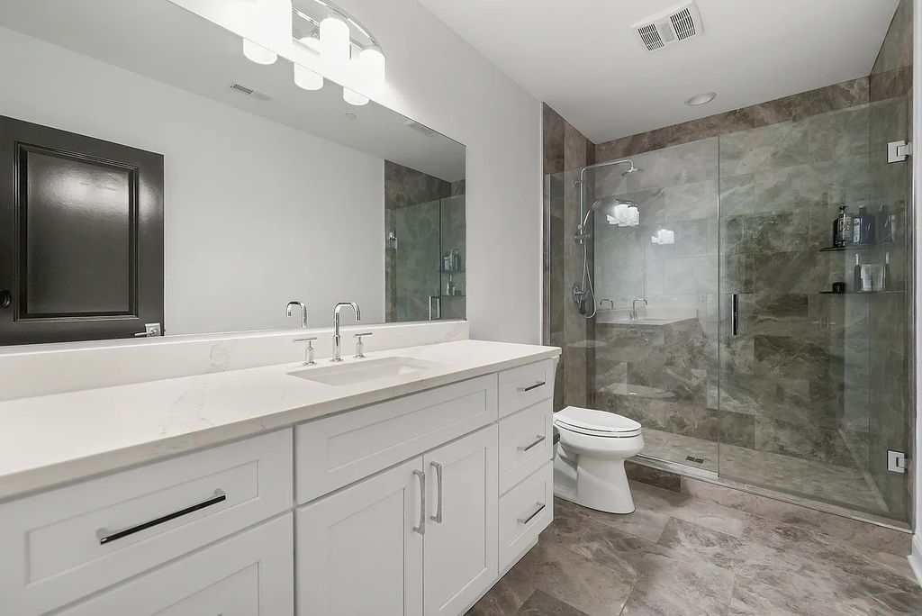 The Estate in Lincolnshire offers a grand scale foyer, ebony oak floors, an open floor plan, soaring ceiling heights, custom luxury finishes throughout now available for sale. This home located at 23477 N Elm Rd, Lincolnshire, Illinois