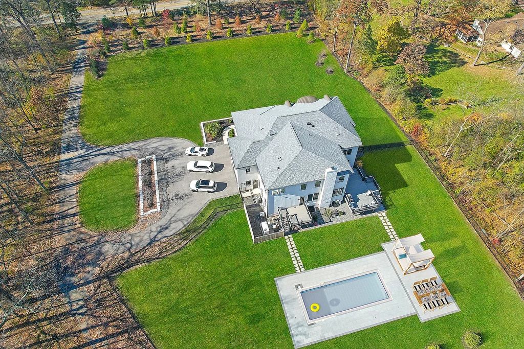 The Estate in Lincolnshire offers a grand scale foyer, ebony oak floors, an open floor plan, soaring ceiling heights, custom luxury finishes throughout now available for sale. This home located at 23477 N Elm Rd, Lincolnshire, Illinois
