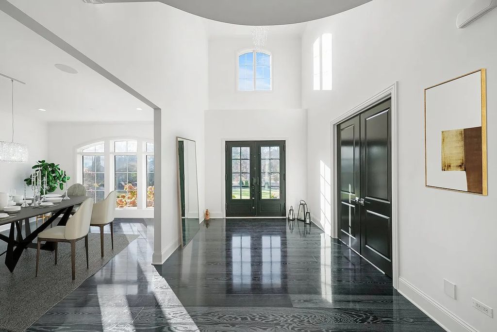 The Estate in Lincolnshire offers a grand scale foyer, ebony oak floors, an open floor plan, soaring ceiling heights, custom luxury finishes throughout now available for sale. This home located at 23477 N Elm Rd, Lincolnshire, Illinois