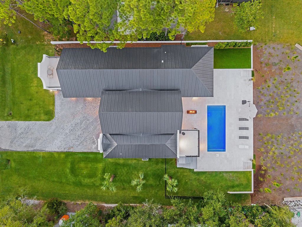458 Shipwreck Rodd E, Santa Rosa Beach, Florida is a stunning new bayfront home boasts generous indoor and outdoor areas for entertaining, including 2,300 square feet of shell stone on the rear patio.