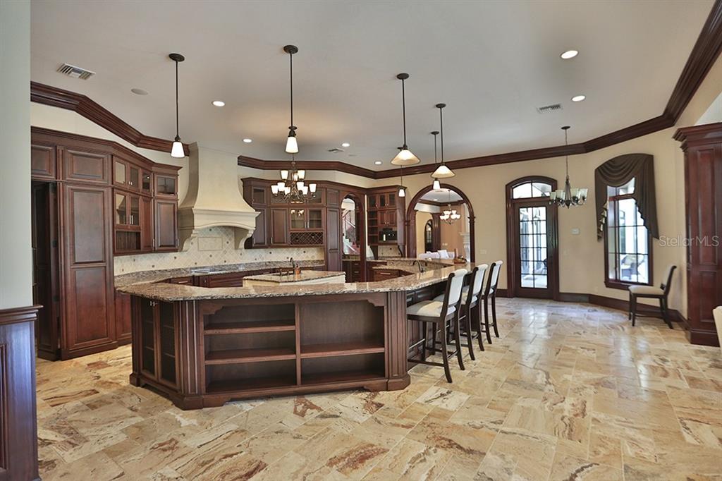 3956 NW 85th Terrace, Ocala, Florida is a spectacular residence perfect for family living and entertaining with open floor plan, resort style screen enclosed pool, summer kitchen, beautiful sunsets overlooking the golf course.