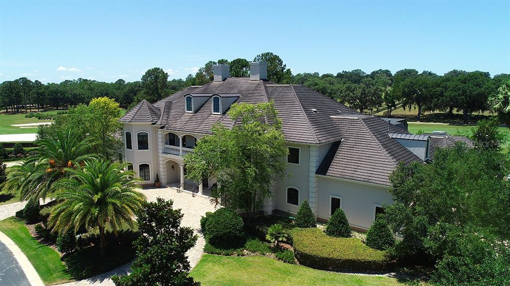 3956 NW 85th Terrace, Ocala, Florida is a spectacular residence perfect for family living and entertaining with open floor plan, resort style screen enclosed pool, summer kitchen, beautiful sunsets overlooking the golf course.