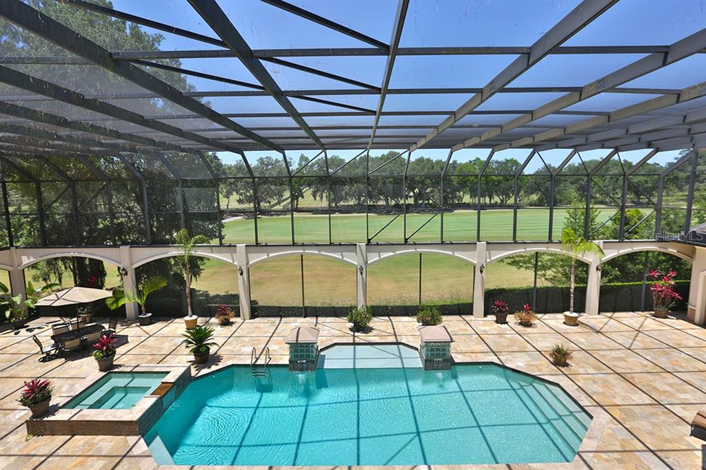 3956 NW 85th Terrace, Ocala, Florida is a spectacular residence perfect for family living and entertaining with open floor plan, resort style screen enclosed pool, summer kitchen, beautiful sunsets overlooking the golf course.