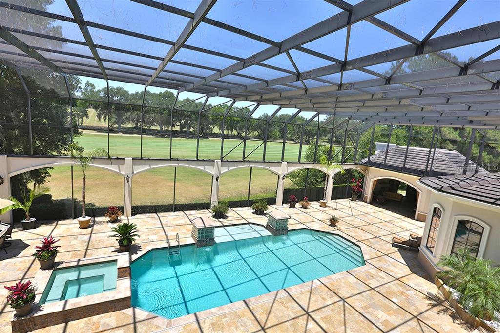 3956 NW 85th Terrace, Ocala, Florida is a spectacular residence perfect for family living and entertaining with open floor plan, resort style screen enclosed pool, summer kitchen, beautiful sunsets overlooking the golf course.