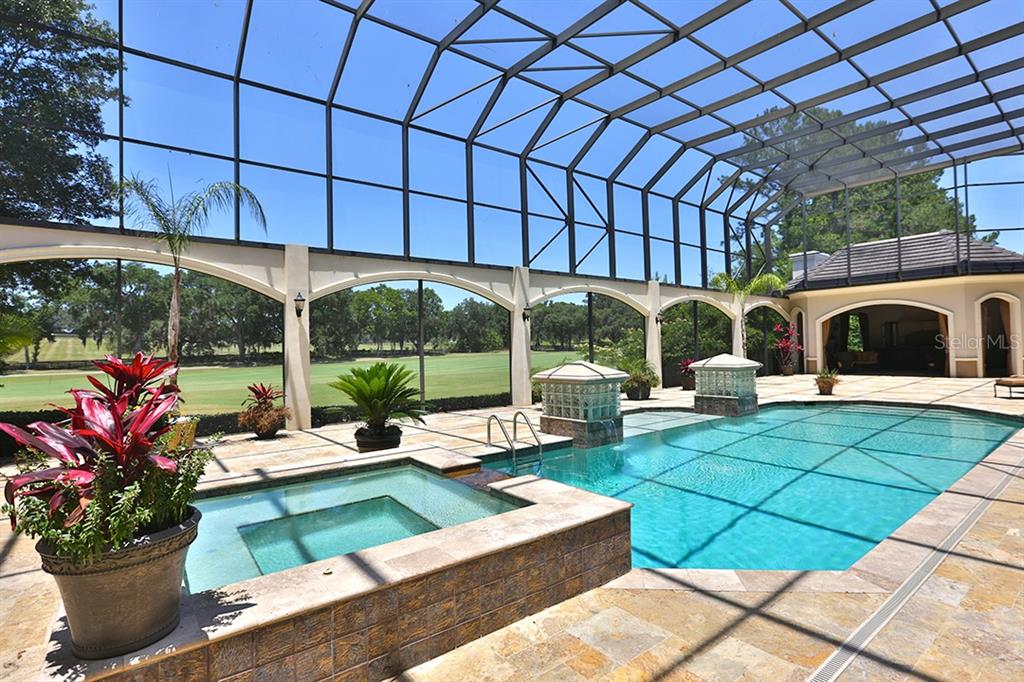 3956 NW 85th Terrace, Ocala, Florida is a spectacular residence perfect for family living and entertaining with open floor plan, resort style screen enclosed pool, summer kitchen, beautiful sunsets overlooking the golf course.