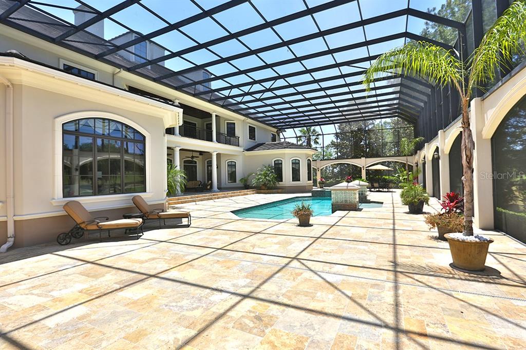 3956 NW 85th Terrace, Ocala, Florida is a spectacular residence perfect for family living and entertaining with open floor plan, resort style screen enclosed pool, summer kitchen, beautiful sunsets overlooking the golf course.