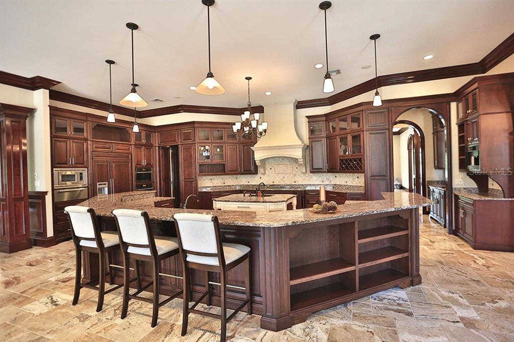 3956 NW 85th Terrace, Ocala, Florida is a spectacular residence perfect for family living and entertaining with open floor plan, resort style screen enclosed pool, summer kitchen, beautiful sunsets overlooking the golf course.