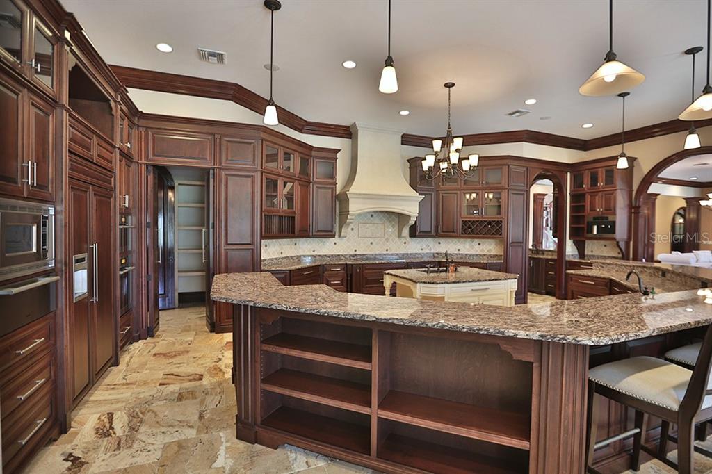 3956 NW 85th Terrace, Ocala, Florida is a spectacular residence perfect for family living and entertaining with open floor plan, resort style screen enclosed pool, summer kitchen, beautiful sunsets overlooking the golf course.