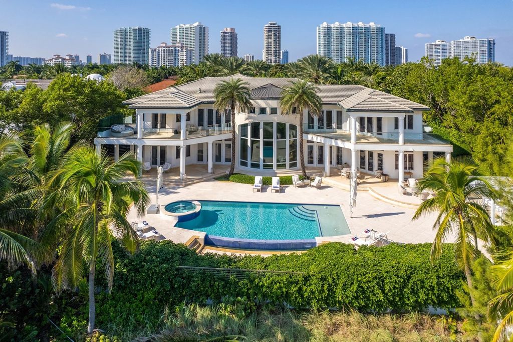 317 Ocean Boulevard, Golden Beach, Florida is an exceptional ocean front estate with luxurious amenities including formal dining room with maple paneling, movie theater, elevator, help quarters, finished basement, gym, and 2 large storage rooms. 