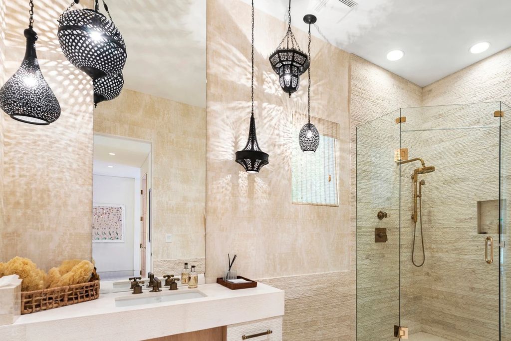 317 Ocean Boulevard, Golden Beach, Florida is an exceptional ocean front estate with luxurious amenities including formal dining room with maple paneling, movie theater, elevator, help quarters, finished basement, gym, and 2 large storage rooms. 