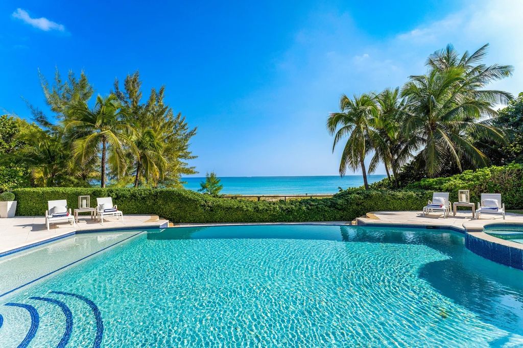 317 Ocean Boulevard, Golden Beach, Florida is an exceptional ocean front estate with luxurious amenities including formal dining room with maple paneling, movie theater, elevator, help quarters, finished basement, gym, and 2 large storage rooms. 