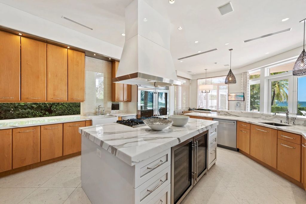 317 Ocean Boulevard, Golden Beach, Florida is an exceptional ocean front estate with luxurious amenities including formal dining room with maple paneling, movie theater, elevator, help quarters, finished basement, gym, and 2 large storage rooms. 
