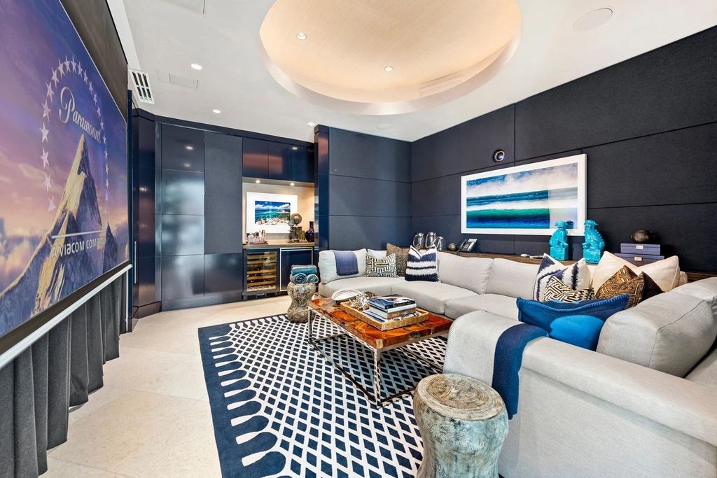 317 Ocean Boulevard, Golden Beach, Florida is an exceptional ocean front estate with luxurious amenities including formal dining room with maple paneling, movie theater, elevator, help quarters, finished basement, gym, and 2 large storage rooms. 