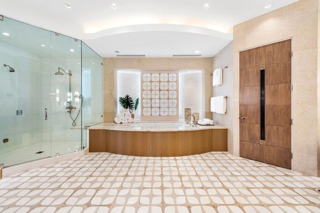 317 Ocean Boulevard, Golden Beach, Florida is an exceptional ocean front estate with luxurious amenities including formal dining room with maple paneling, movie theater, elevator, help quarters, finished basement, gym, and 2 large storage rooms. 
