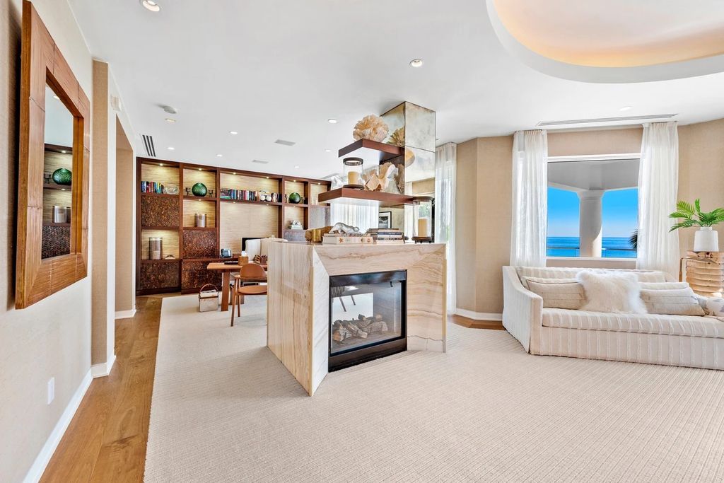 317 Ocean Boulevard, Golden Beach, Florida is an exceptional ocean front estate with luxurious amenities including formal dining room with maple paneling, movie theater, elevator, help quarters, finished basement, gym, and 2 large storage rooms. 