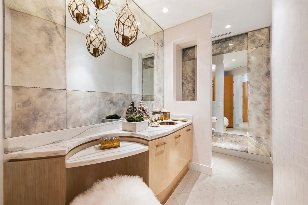 317 Ocean Boulevard, Golden Beach, Florida is an exceptional ocean front estate with luxurious amenities including formal dining room with maple paneling, movie theater, elevator, help quarters, finished basement, gym, and 2 large storage rooms. 