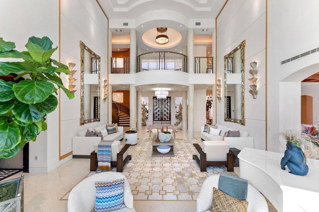 317 Ocean Boulevard, Golden Beach, Florida is an exceptional ocean front estate with luxurious amenities including formal dining room with maple paneling, movie theater, elevator, help quarters, finished basement, gym, and 2 large storage rooms. 