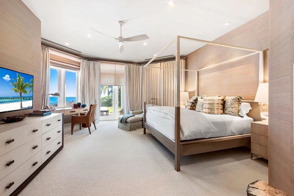 317 Ocean Boulevard, Golden Beach, Florida is an exceptional ocean front estate with luxurious amenities including formal dining room with maple paneling, movie theater, elevator, help quarters, finished basement, gym, and 2 large storage rooms. 