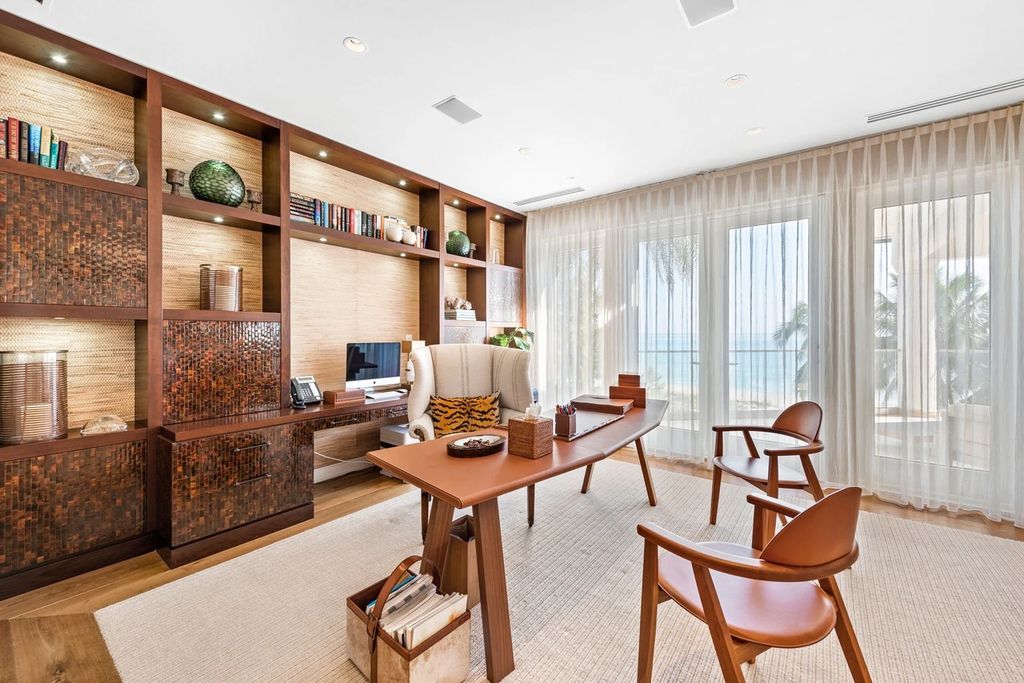 317 Ocean Boulevard, Golden Beach, Florida is an exceptional ocean front estate with luxurious amenities including formal dining room with maple paneling, movie theater, elevator, help quarters, finished basement, gym, and 2 large storage rooms. 