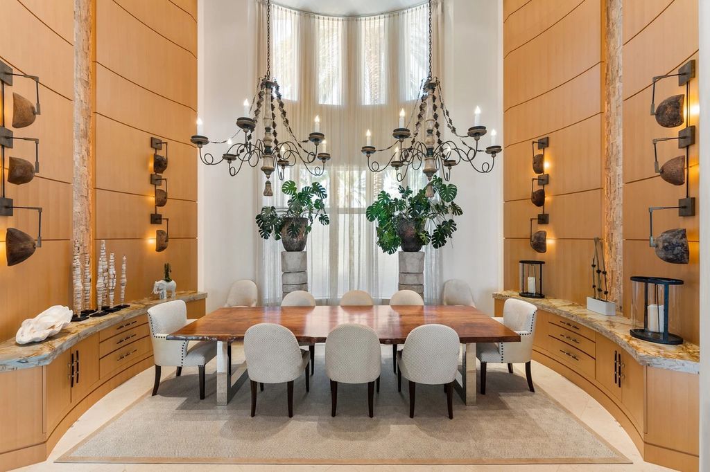 317 Ocean Boulevard, Golden Beach, Florida is an exceptional ocean front estate with luxurious amenities including formal dining room with maple paneling, movie theater, elevator, help quarters, finished basement, gym, and 2 large storage rooms. 