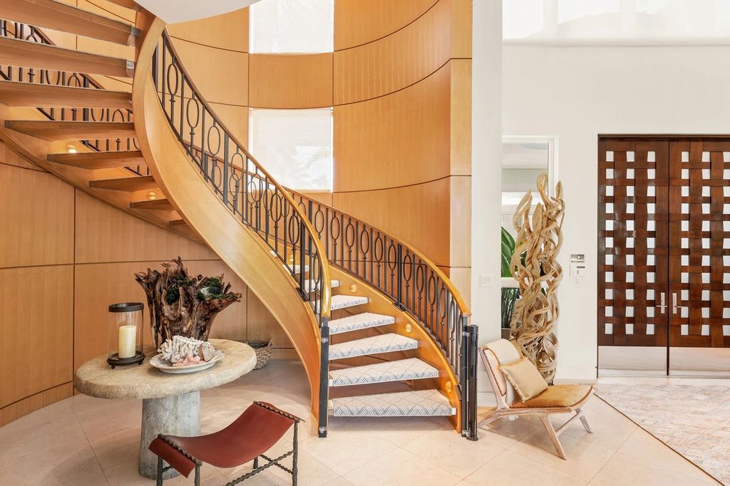 317 Ocean Boulevard, Golden Beach, Florida is an exceptional ocean front estate with luxurious amenities including formal dining room with maple paneling, movie theater, elevator, help quarters, finished basement, gym, and 2 large storage rooms. 