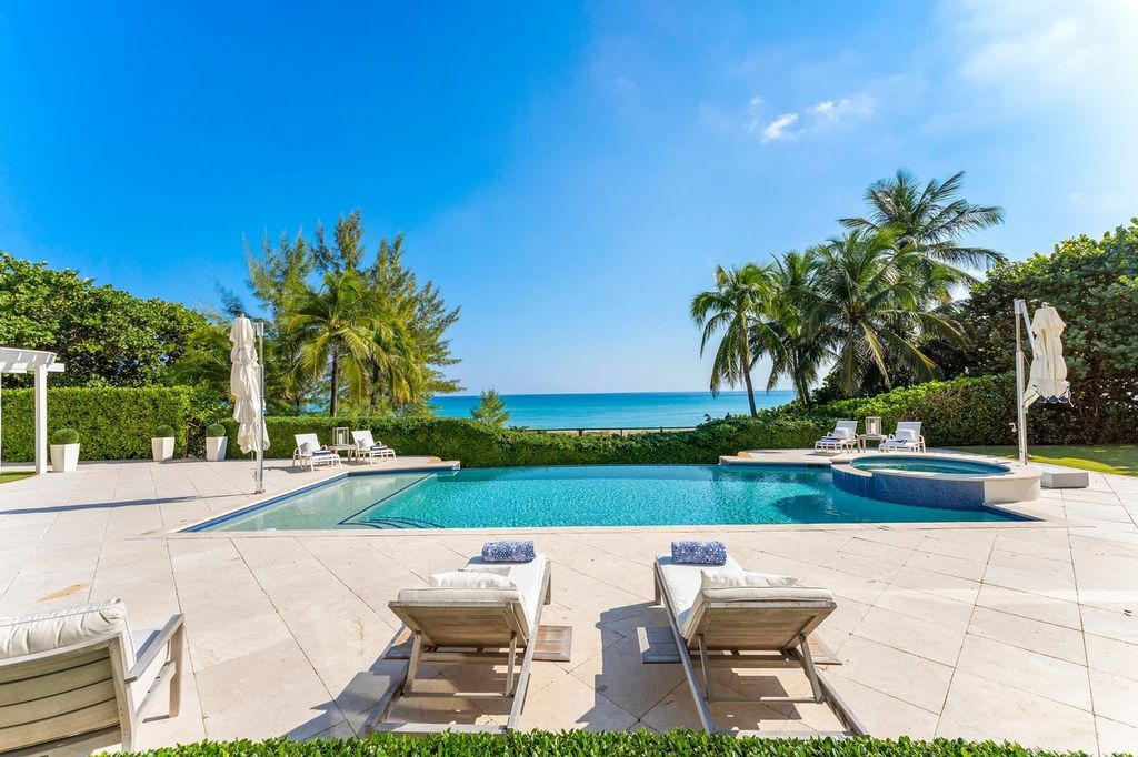 317 Ocean Boulevard, Golden Beach, Florida is an exceptional ocean front estate with luxurious amenities including formal dining room with maple paneling, movie theater, elevator, help quarters, finished basement, gym, and 2 large storage rooms. 