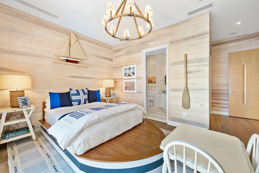 317 Ocean Boulevard, Golden Beach, Florida is an exceptional ocean front estate with luxurious amenities including formal dining room with maple paneling, movie theater, elevator, help quarters, finished basement, gym, and 2 large storage rooms. 