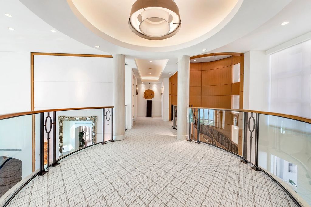 317 Ocean Boulevard, Golden Beach, Florida is an exceptional ocean front estate with luxurious amenities including formal dining room with maple paneling, movie theater, elevator, help quarters, finished basement, gym, and 2 large storage rooms. 