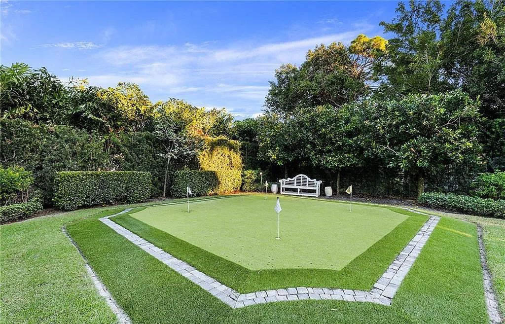 482 Ridge Drive, Naples, Florida, is located in a desirable Naples neighborhood, just minutes from Vanderbilt Beach, Mercato, and Waterside shops. This stunning home was built with meticulous attention to detail, including a butterfly staircase and marble floors.