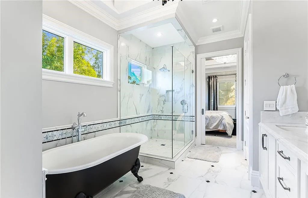 482 Ridge Drive, Naples, Florida, is located in a desirable Naples neighborhood, just minutes from Vanderbilt Beach, Mercato, and Waterside shops. This stunning home was built with meticulous attention to detail, including a butterfly staircase and marble floors.