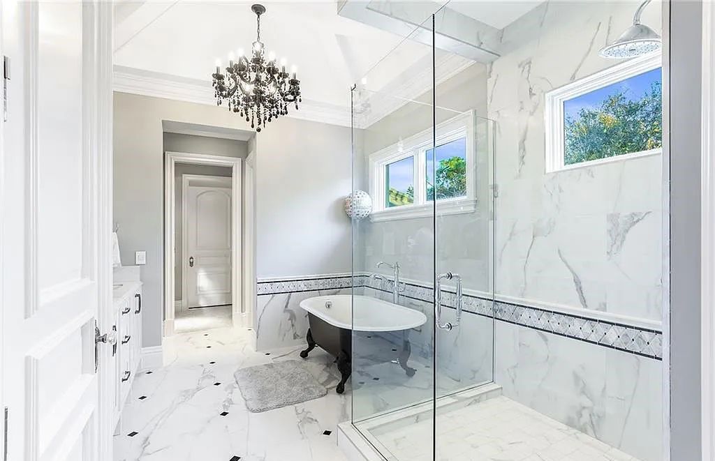 482 Ridge Drive, Naples, Florida, is located in a desirable Naples neighborhood, just minutes from Vanderbilt Beach, Mercato, and Waterside shops. This stunning home was built with meticulous attention to detail, including a butterfly staircase and marble floors.