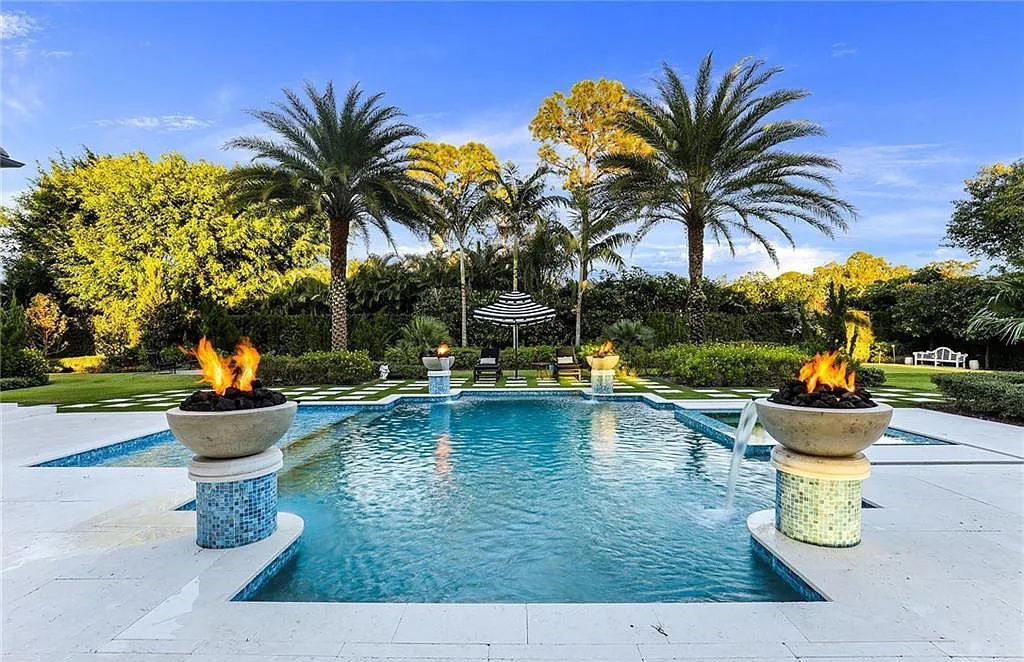 482 Ridge Drive, Naples, Florida, is located in a desirable Naples neighborhood, just minutes from Vanderbilt Beach, Mercato, and Waterside shops. This stunning home was built with meticulous attention to detail, including a butterfly staircase and marble floors.