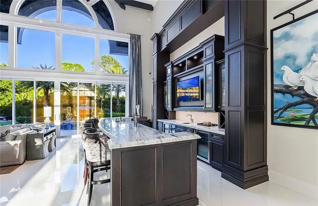 482 Ridge Drive, Naples, Florida, is located in a desirable Naples neighborhood, just minutes from Vanderbilt Beach, Mercato, and Waterside shops. This stunning home was built with meticulous attention to detail, including a butterfly staircase and marble floors.