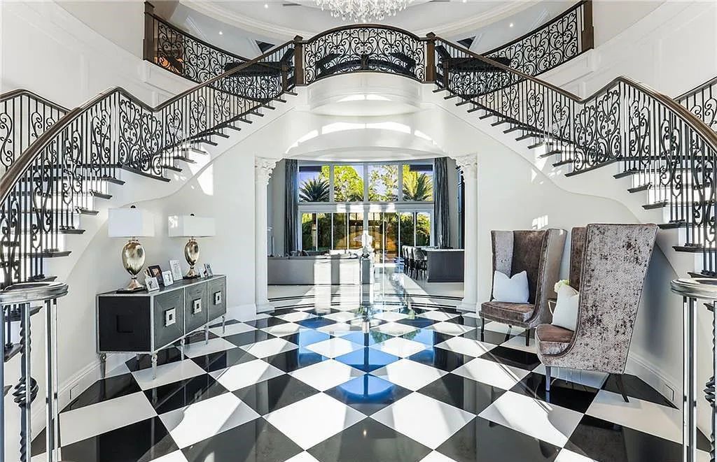 482 Ridge Drive, Naples, Florida, is located in a desirable Naples neighborhood, just minutes from Vanderbilt Beach, Mercato, and Waterside shops. This stunning home was built with meticulous attention to detail, including a butterfly staircase and marble floors.