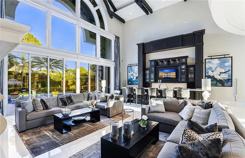 482 Ridge Drive, Naples, Florida, is located in a desirable Naples neighborhood, just minutes from Vanderbilt Beach, Mercato, and Waterside shops. This stunning home was built with meticulous attention to detail, including a butterfly staircase and marble floors.