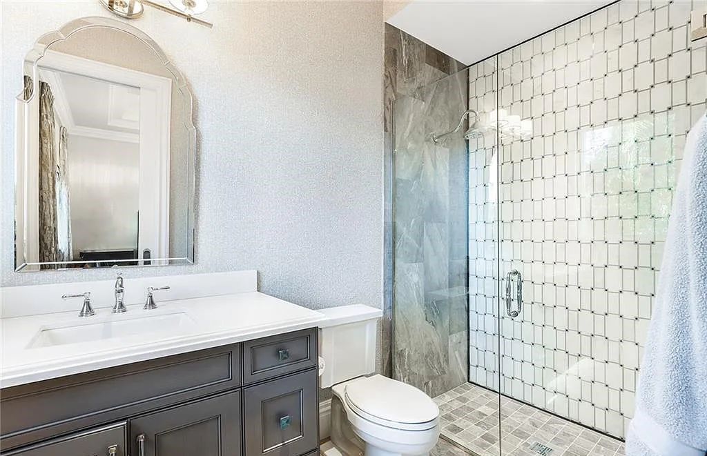 482 Ridge Drive, Naples, Florida, is located in a desirable Naples neighborhood, just minutes from Vanderbilt Beach, Mercato, and Waterside shops. This stunning home was built with meticulous attention to detail, including a butterfly staircase and marble floors.