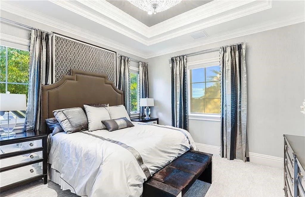482 Ridge Drive, Naples, Florida, is located in a desirable Naples neighborhood, just minutes from Vanderbilt Beach, Mercato, and Waterside shops. This stunning home was built with meticulous attention to detail, including a butterfly staircase and marble floors.